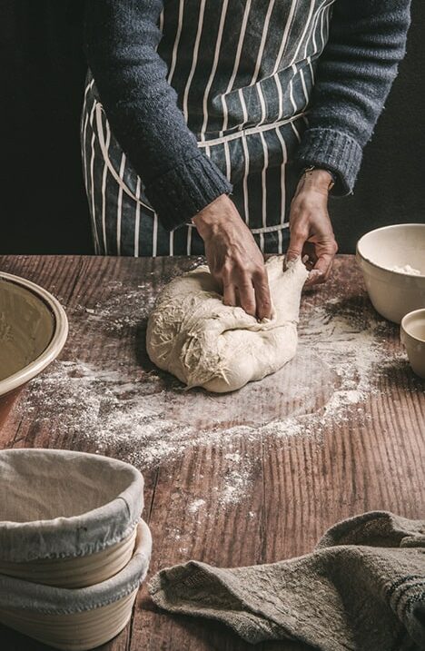 Gentleman kneading bread dough