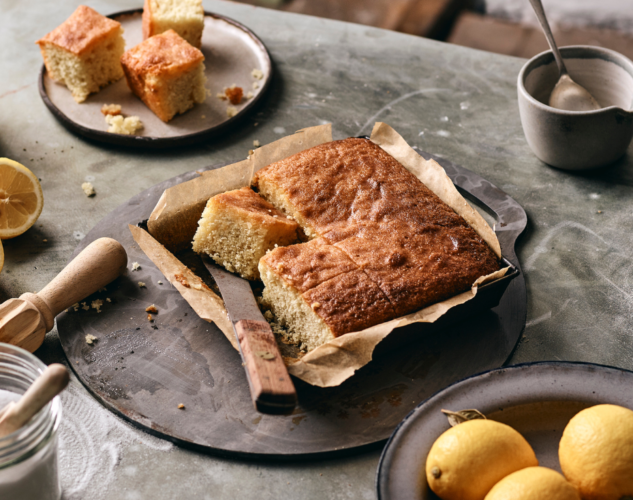 Photo of lemon drizzle tray bake cut up into slices